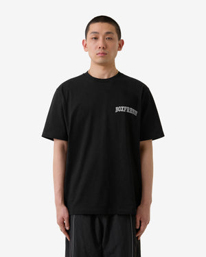 Person wearing a black t-shirt with 'Boxfresh' logo on a white background