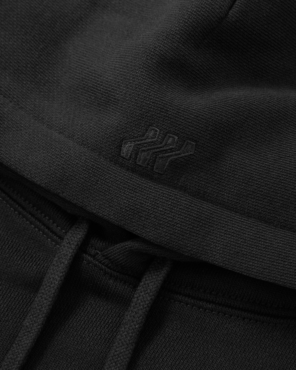 Flatpack, front view of a black hoodie. 