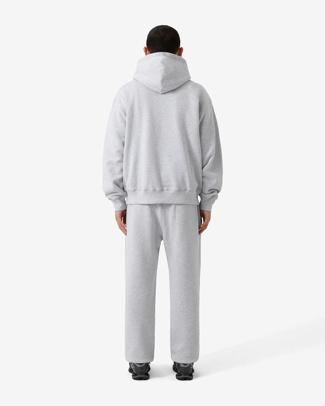 Back view of a model wearing a matching hoodie and pants as a set. 
