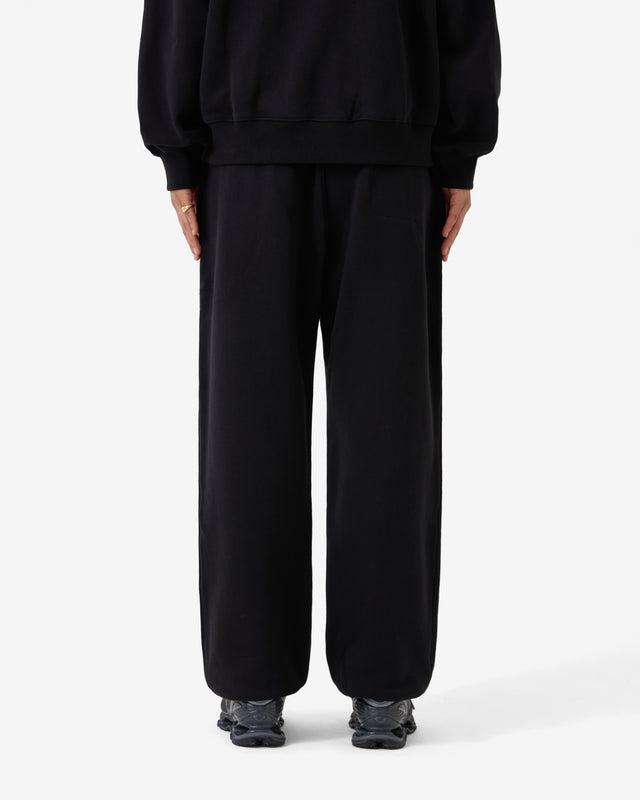 Person wearing a black outfit on a white background