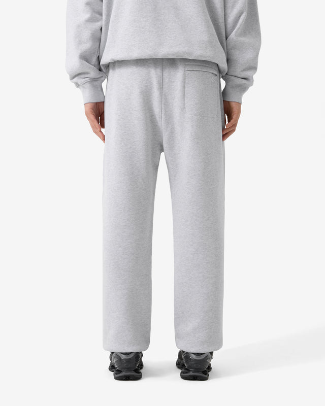 Person wearing gray sweatpants on a white background