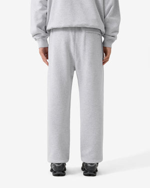 Person wearing gray sweatpants on a white background