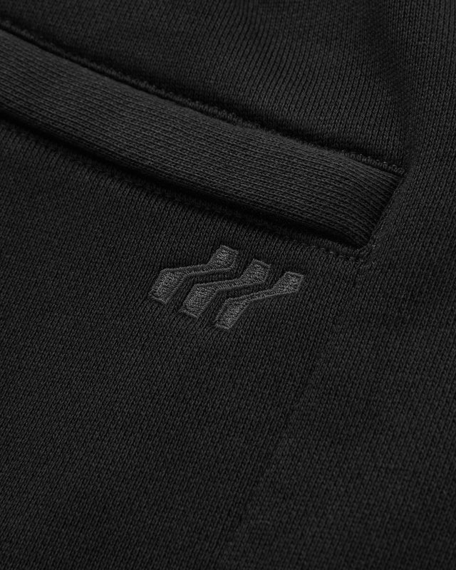 Close-up of a black sweatshirt with a brand logo on the chest pocket.