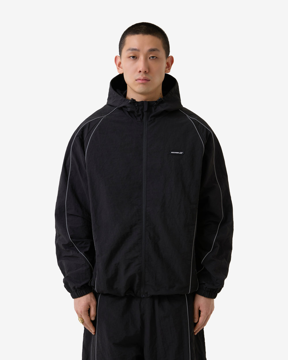 Black jacket with white accents on a light gray background