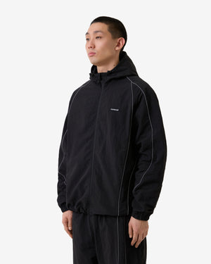 Person wearing a black jacket with a brand logo on a white background