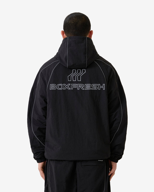 Person wearing a black hoodie with 'BOXFRESH' branding on the back against a white background