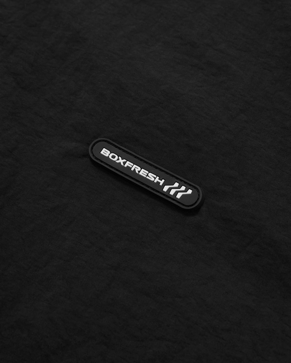Black jacket with white accents on a light gray background