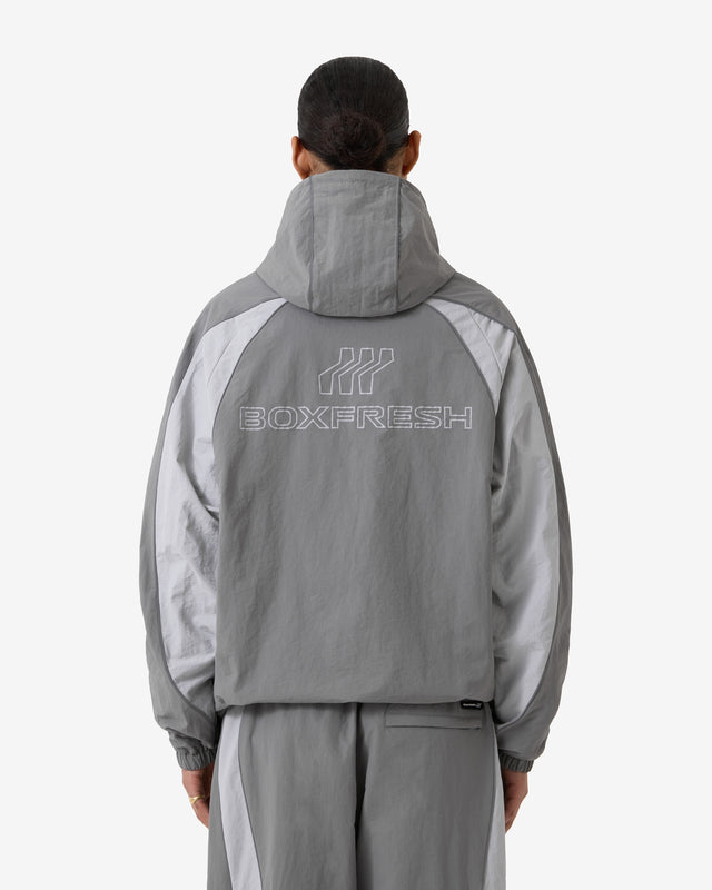 Person wearing a gray tracksuit with 'Boxfresh' logo on a white background