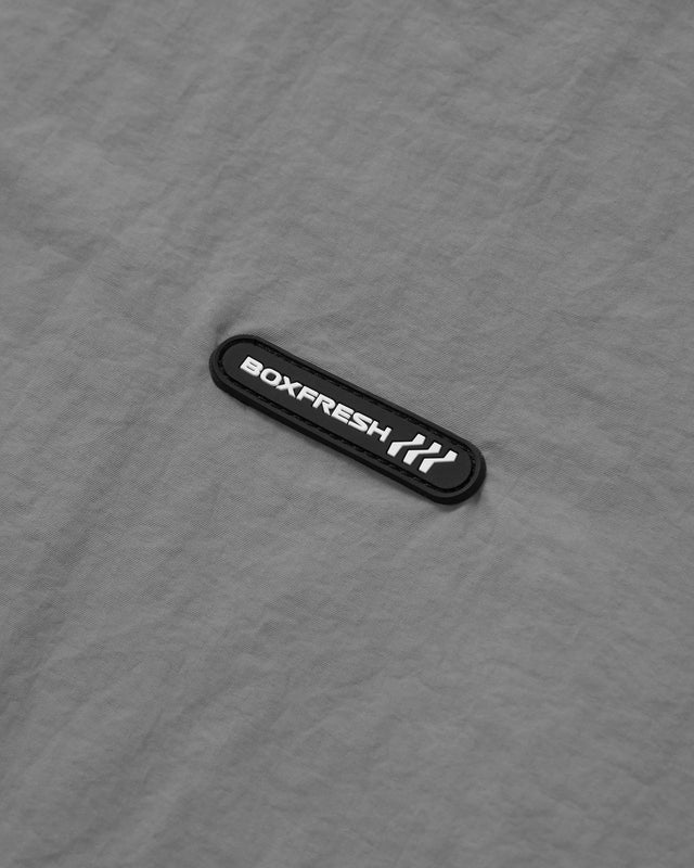 Close up image of the BOXFRESH logo tag on a garment. 
