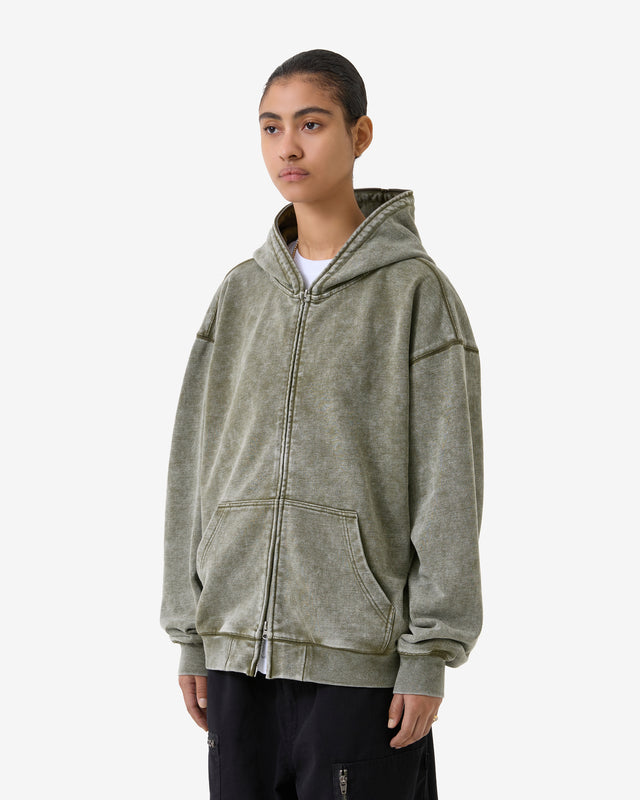 Person wearing a green hoodie on a white background