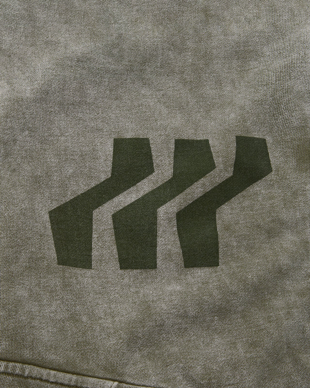 Close-up of a textured gray fabric with a black logo on a gray background
