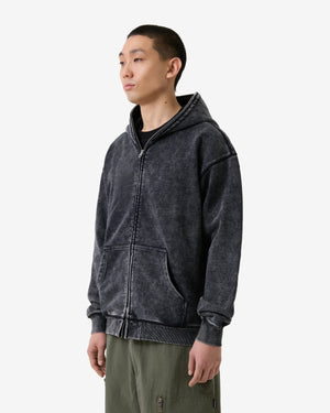 Person wearing a dark gray hoodie on a white background