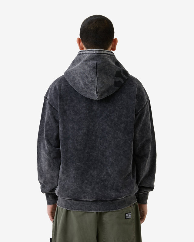 Person wearing a dark gray hoodie with a visible brand logo on a white background