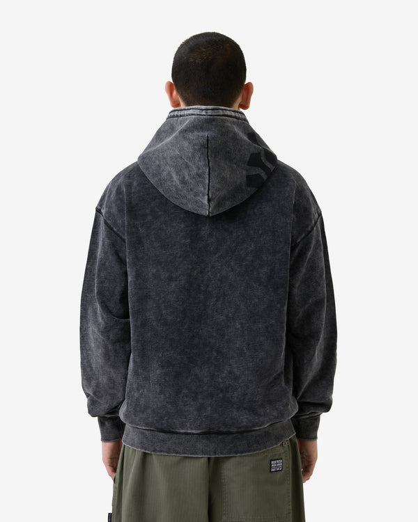 Person wearing a dark gray hoodie with a visible brand logo on a white background