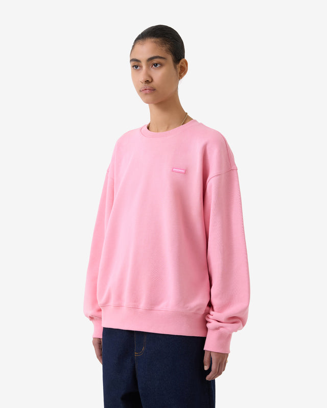 Person wearing a pink sweatshirt on a white background