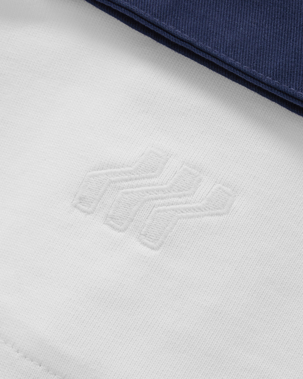 White and navy polo shirt with 'BOXFRESH' branding on a white background