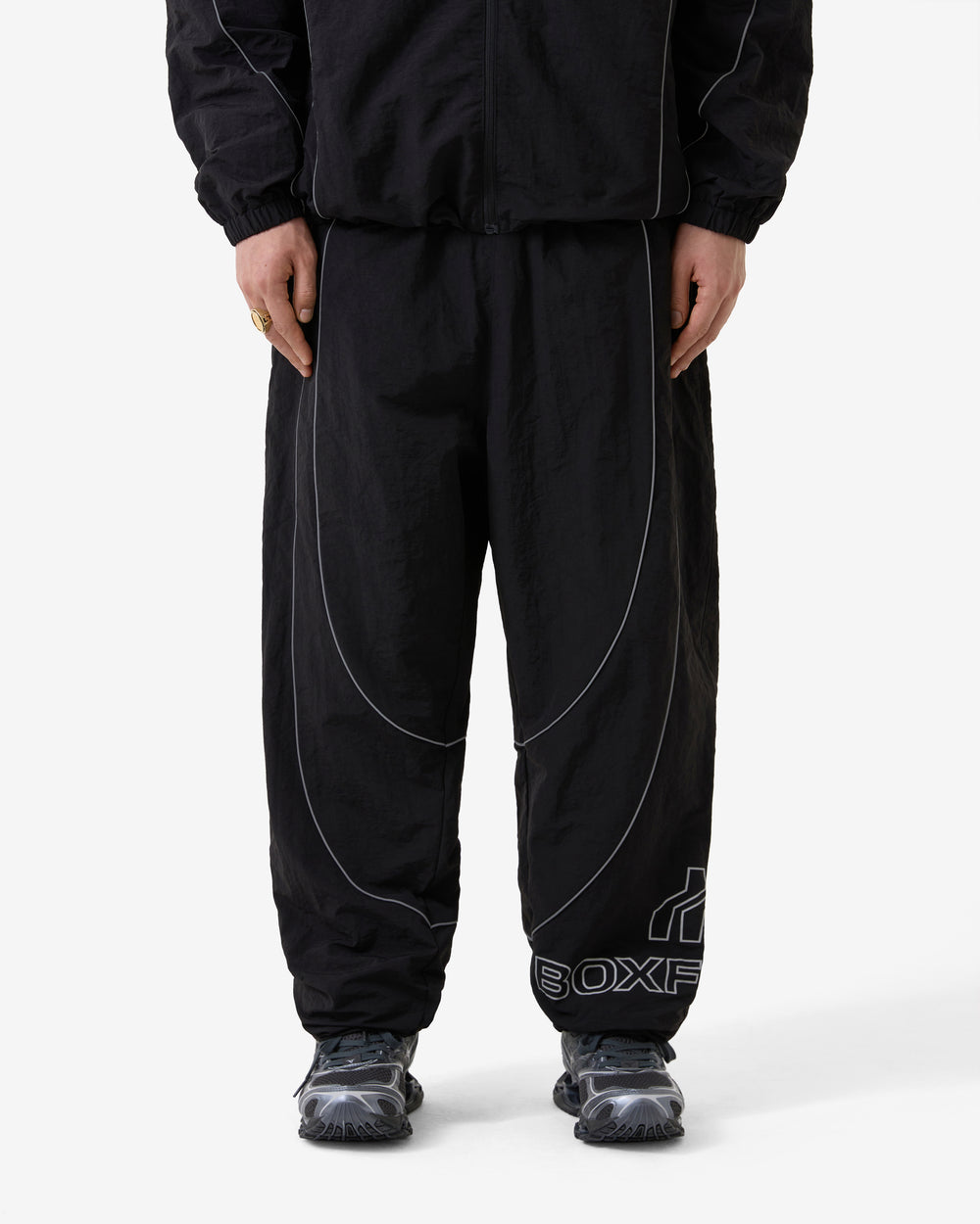 Black pants with white lines and 'BOXXER' branding on a white background