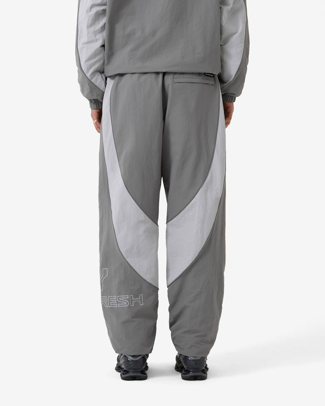 Person wearing gray tracksuit with 'FRESH' branding on a white background