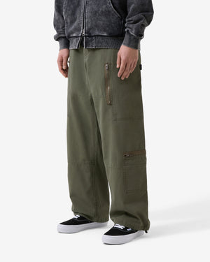 Person wearing olive green cargo pants on a white background