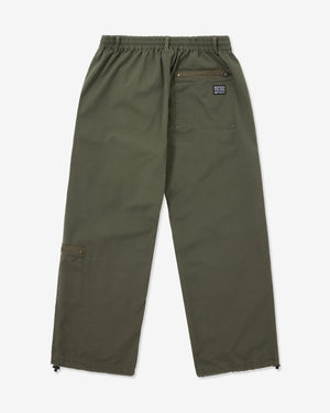 Green pants with a brand patch on a white background