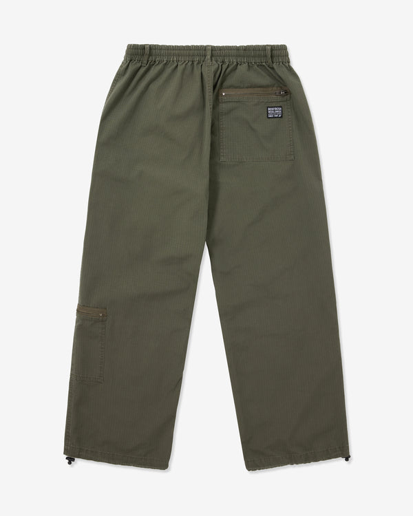 Green pants with a brand patch on a white background