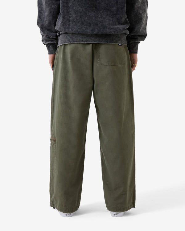 Person wearing olive green pants and a dark gray sweatshirt on a white background