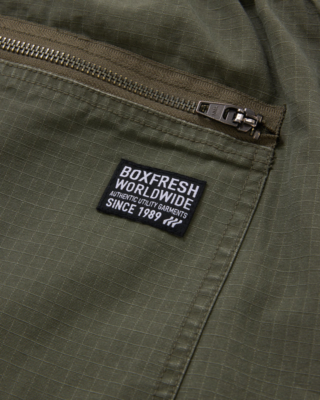 Green jacket with a 'Boxfresh Worldwide' label on a pocket