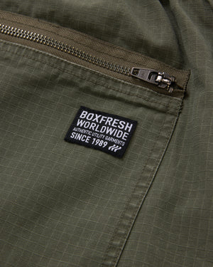 Green jacket with a 'Boxfresh Worldwide' label on a pocket