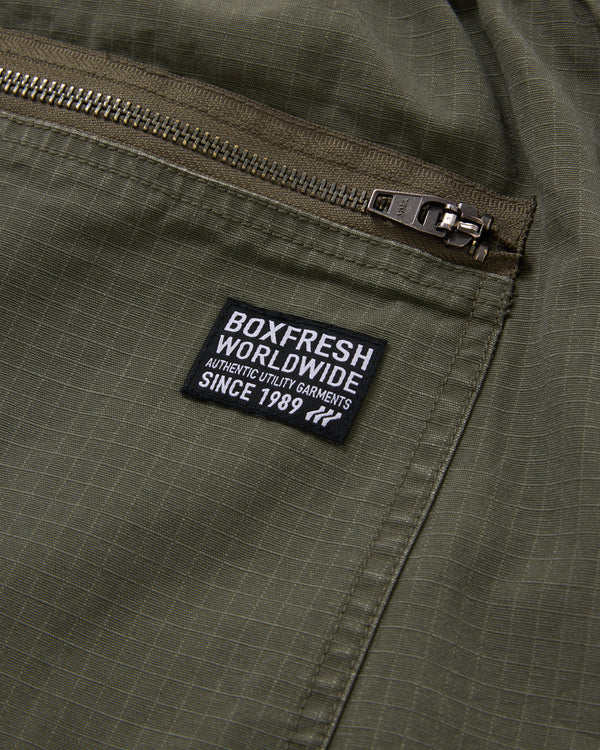 Green jacket with a 'Boxfresh Worldwide' label on a pocket