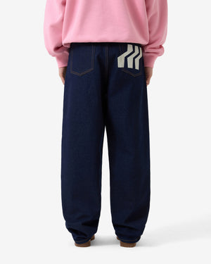 Person wearing navy blue pants with a white stripe on a white background