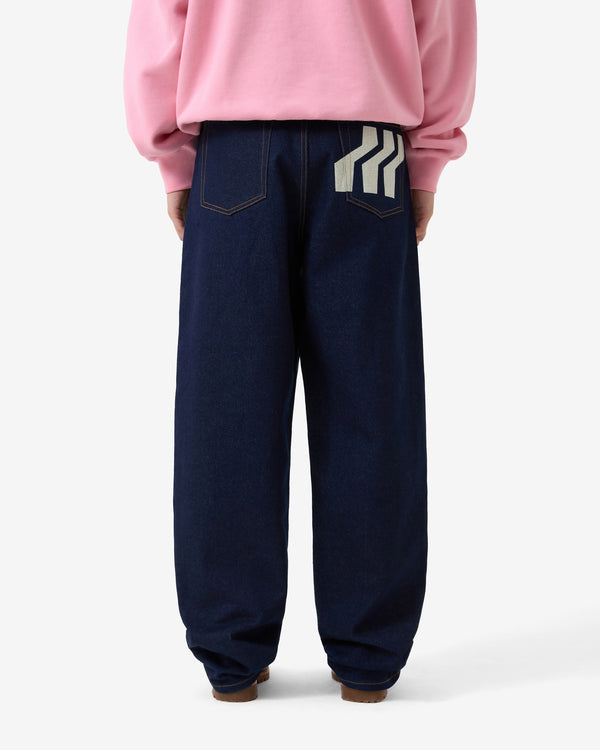 Person wearing navy blue pants with a white stripe on a white background