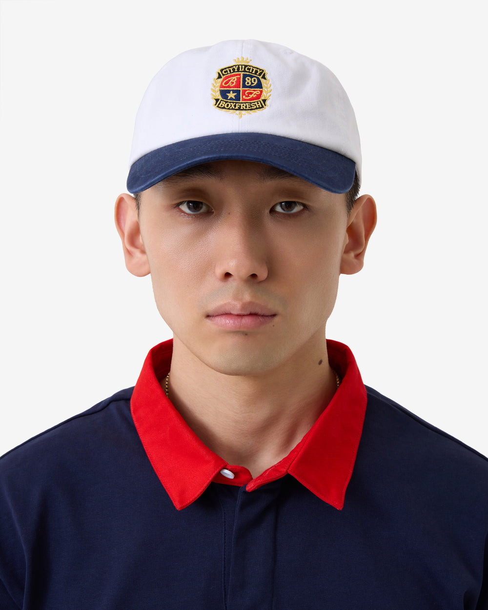 White and navy cap with a logo on a white background