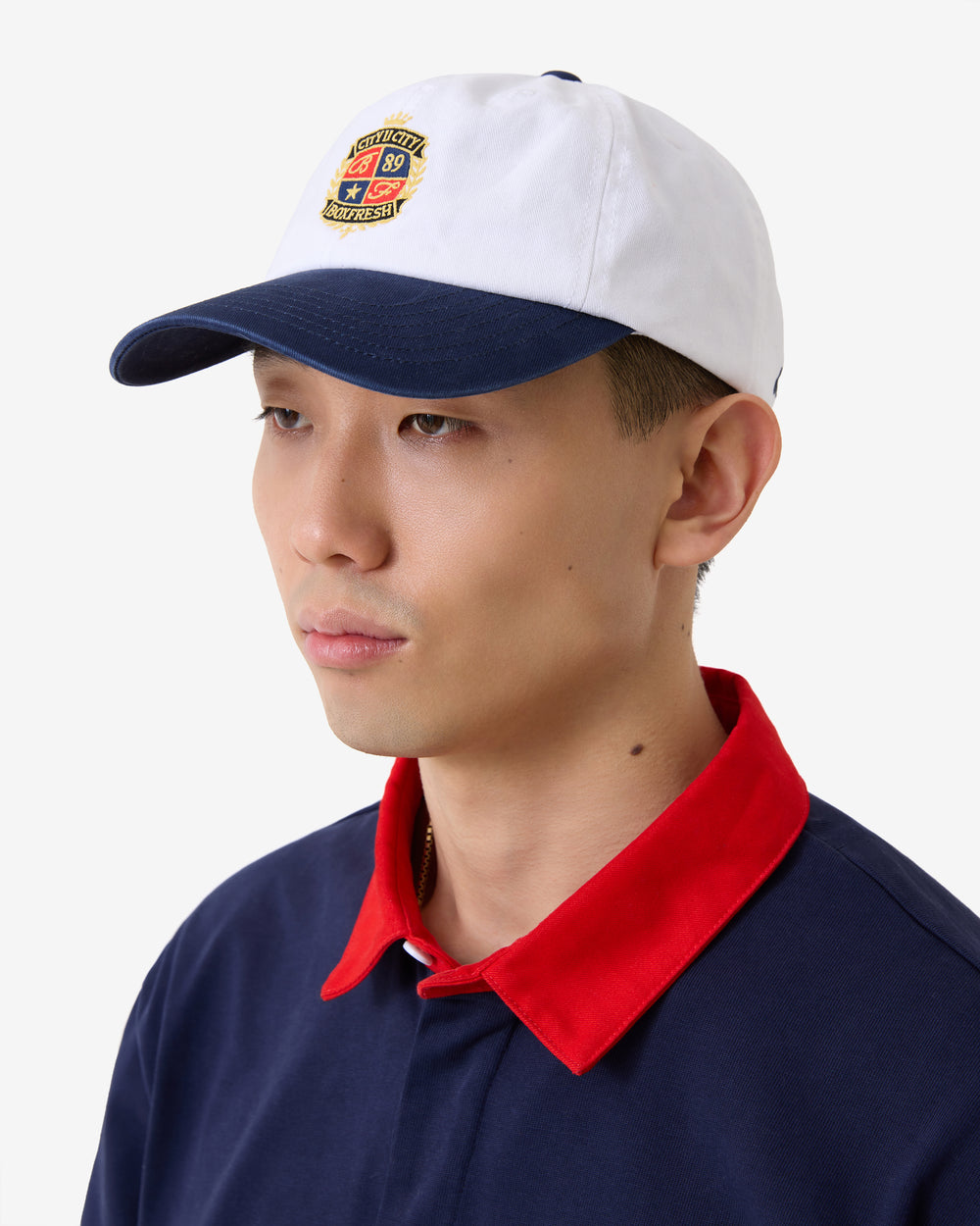 White and navy cap with a logo on a white background